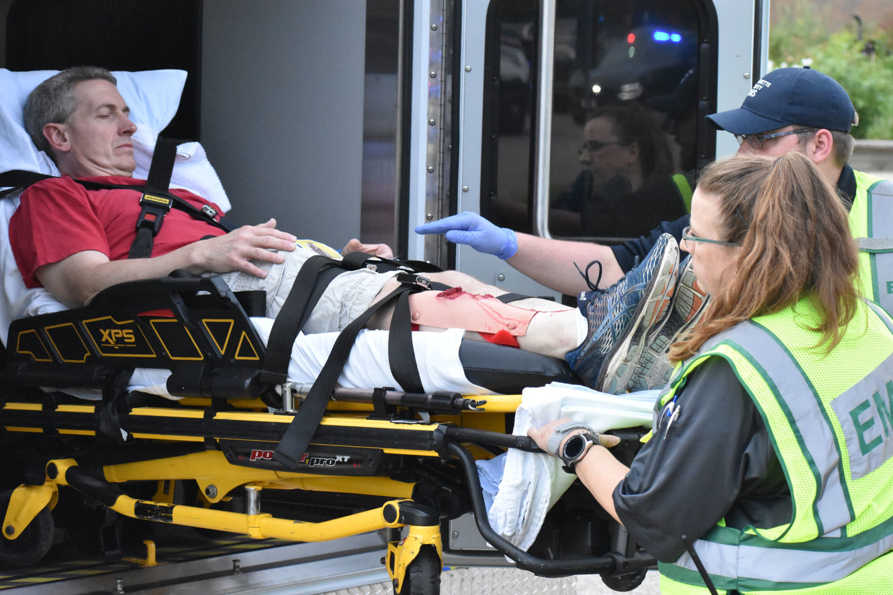 Lifting wounded victim into ambulance